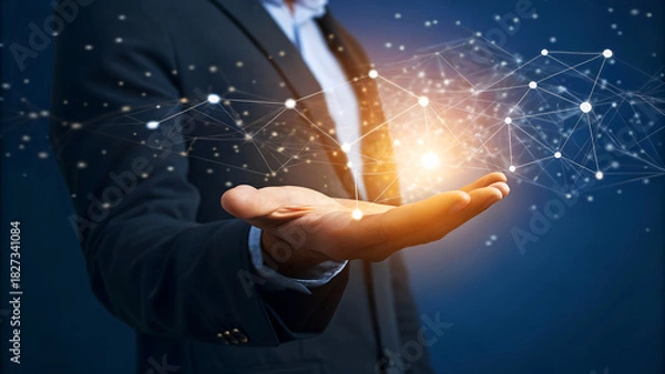 Fototapeta Businessman holding glowing digital network structure, symbolizing innovation and global connectivity in a modern business context.