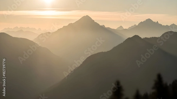 Fototapeta Golden sunlight illuminates layered mountain ranges during a peaceful morning in a remote wilderness landscape. isolated on white background