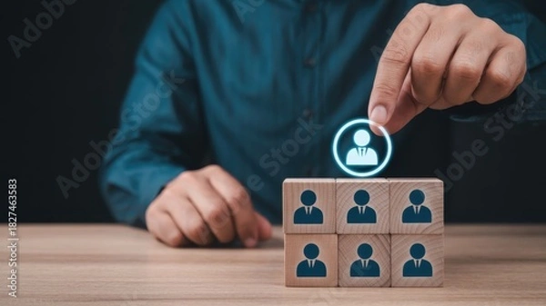 Fototapeta Manager selects an ideal employee from a group represented by wooden blocks