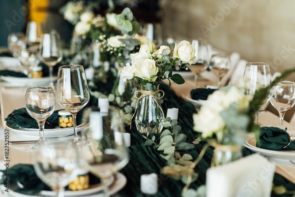 Fototapeta Elegant festive table setting with green decor and glassware