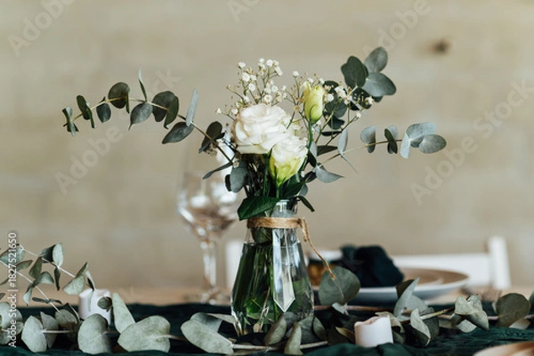 Fototapeta Elegant festive table setting with green decor and glassware