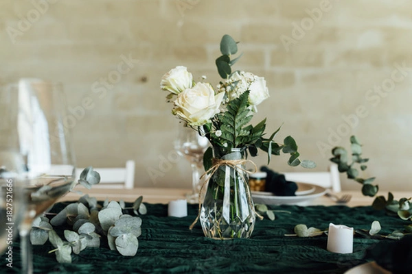 Fototapeta Elegant festive table setting with green decor and glassware