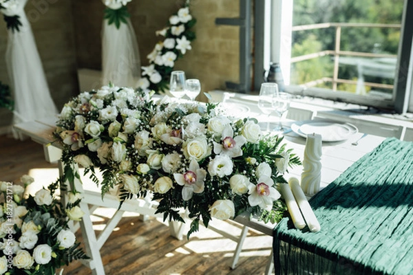 Fototapeta Elegant festive table setting with green decor and glassware