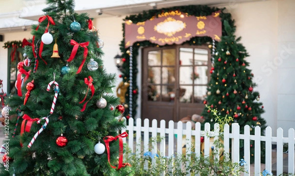 Obraz close-up view, christmas tree with item christmas. white fence with christmas decorate at a door in winter, celebrate in christmas holiday
