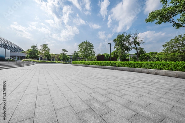 Obraz Empty square floor and modern building with green plants.