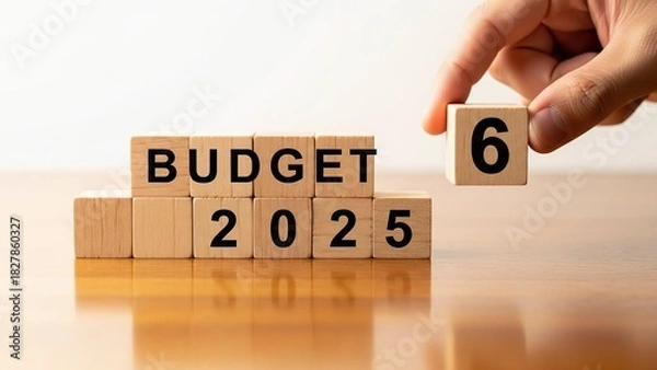 Fototapeta 3d illustration of budget 2026 concept with wooden blocks displaying budget 2025 and a hand adding 6, symbolizing financial planning and future fiscal year isolated on white background