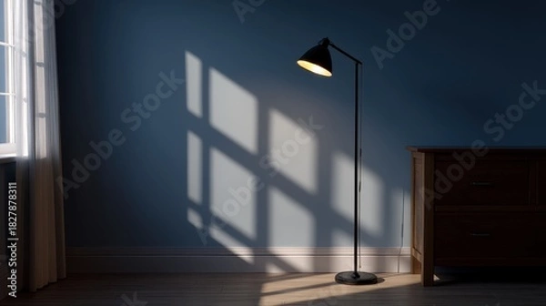 Obraz Long Shadow from Stand Lamp Stretching Across Wall in a Calm Room Environment