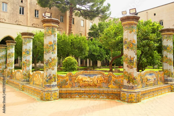 Fototapeta View of the colorful tiled columns of the cloister of Santa Chiara in Naples, Campania, Italy.