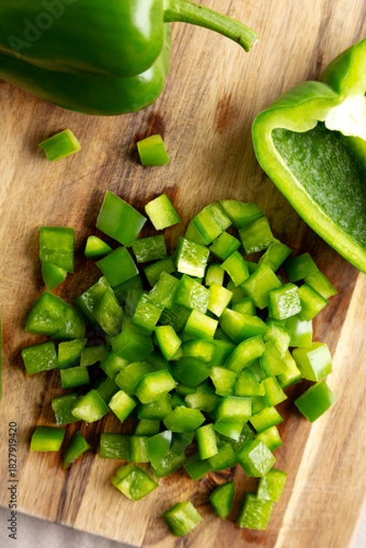 Obraz Organic Chopped Green Bell Peppers arranged on a Cutting Board, top view.