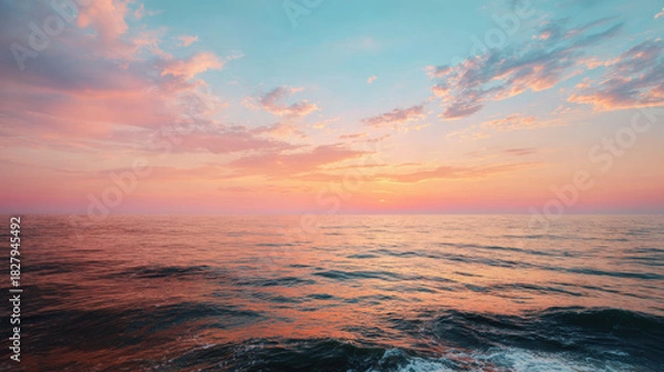 Fototapeta Sunset reflecting on calm ocean water creating beautiful landscape