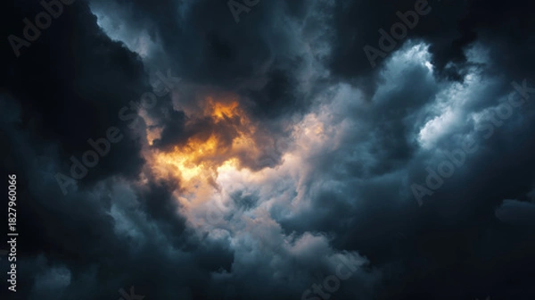 Fototapeta Dramatic clouds with sunlight peeking through in stormy sky