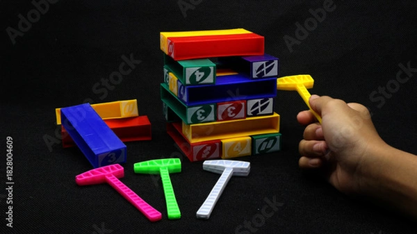 Obraz Colorful uno stacko blocks on black background