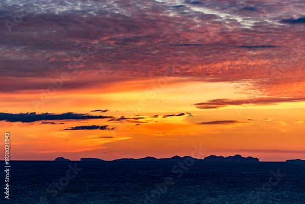 Fototapeta Stunningly beautiful sunset over the ocean as seen from the cape cliffs near the lighthouse of Vik, small city in Southern Iceland, travel tourist destination and sightseeing