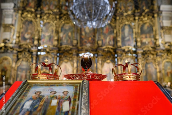 Fototapeta  Two crowns, a cup of wine and a cross prepared for baptism
