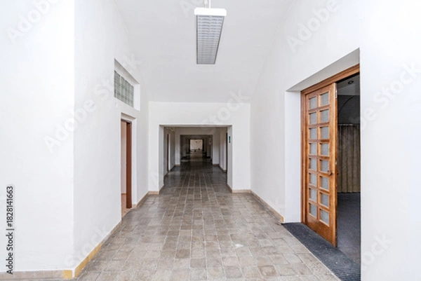 Obraz Empty long hallway perspective with tiled floor and multiple doors