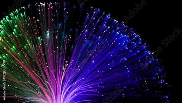 Obraz Close up of fiber optic strands glowing in green pink and blue against a dark black background
