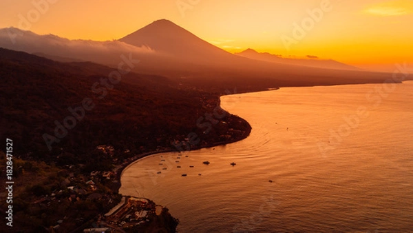 Fototapeta Panorama of coastline with silhouette of volcano and sunset with ocean in Bali.