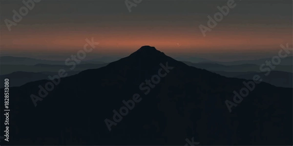 Fototapeta Silhouetted mountain peak at sunset with a dark and moody sky