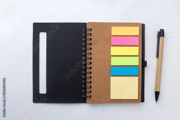 Fototapeta Notebook with post it notes and pen isolated on white background