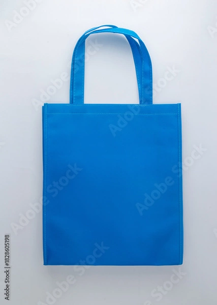 Fototapeta Blue canvas tote bag on white background.