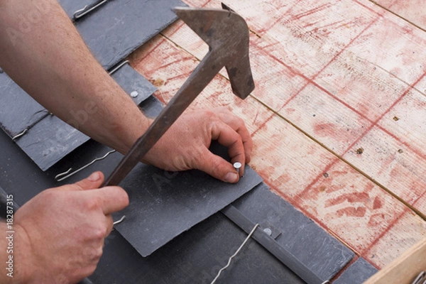 Obraz roofer cut a slate on a stack