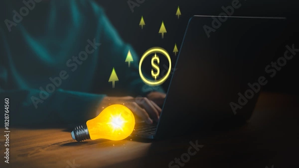 Fototapeta A glowing lightbulb beside a laptop symbolizes creativity, innovation, and online income growth, with digital dollar icons and upward arrows representing business ideas, and financial success.