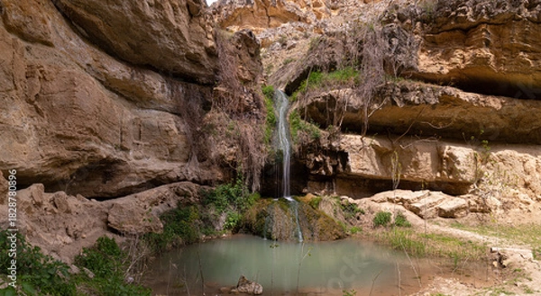 Fototapeta A small waterfall with a lake in the mountains.