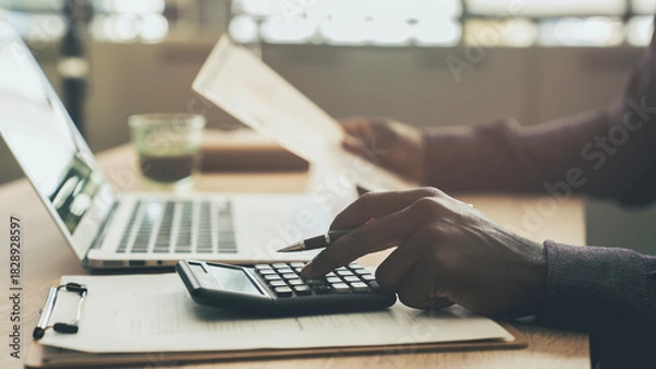 Fototapeta Businessman planning budget in office