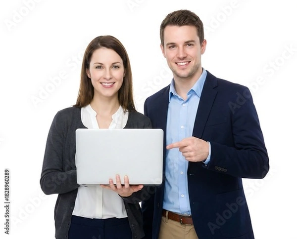 Obraz Happy young business team smiling, standing with laptop, man pointing at screen on white background.