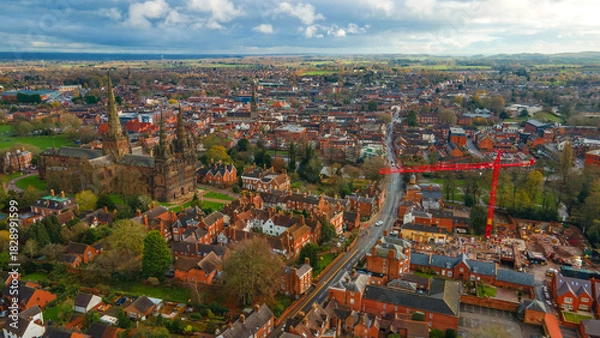 Fototapeta Historic Lichfield Cathedral near busy road and modern building crane