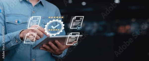 Fototapeta Digital Certification and Verification: A person interacts with a tablet displaying digital certificates and verification symbols, representing quality and approval.