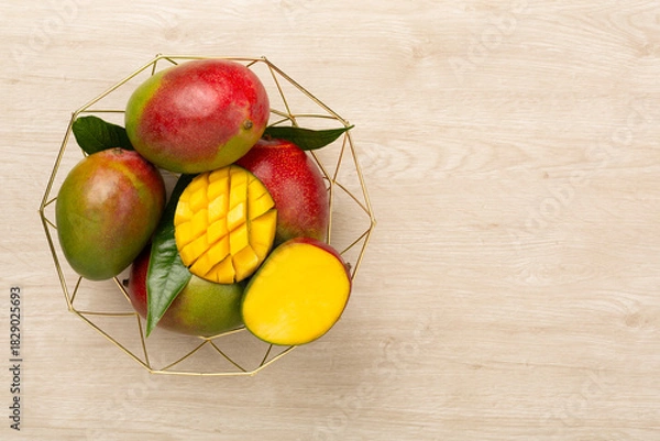 Obraz Fresh ripe mango on wooden background, top view