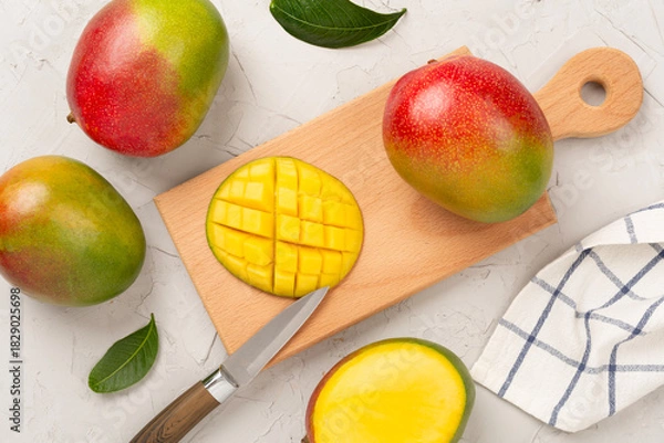 Fototapeta Fresh ripe mango on concrete background, top view