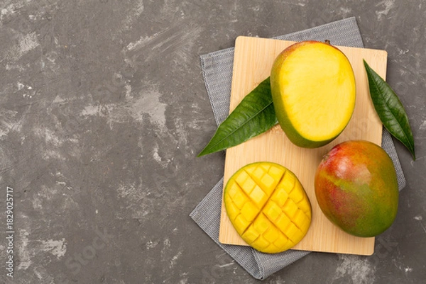 Obraz Fresh ripe mango on concrete background, top view