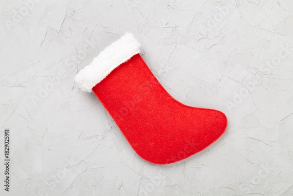 Obraz Christmas sock on concrete background, top view