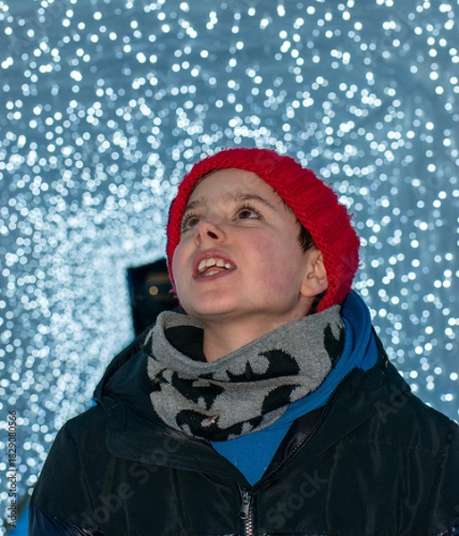 Obraz Boy in Red Pom-Pom Hat Looking at Christmas Lights