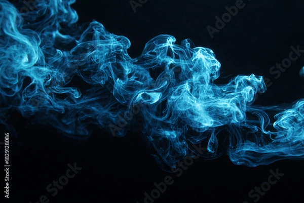 Fototapeta Ethereal blue smoke drifts and swirls against a dark background creating a mesmerizing abstract pattern