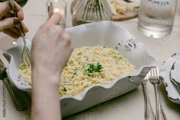 Fototapeta Fresh pasta served in an elegant dish at an intimate dining setting in the evening