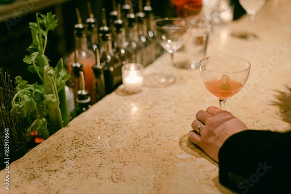 Fototapeta Enjoying a cocktail at a stylish bar with a cozy atmosphere during a night out