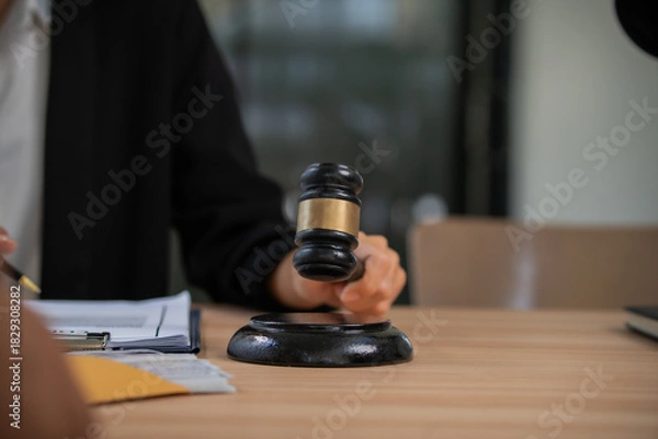 Fototapeta A professional attorney who reviews legal documents, provides fair advice, and strategic guidance in formal court matters, contracts, judgments, partnerships, rights, and powers.