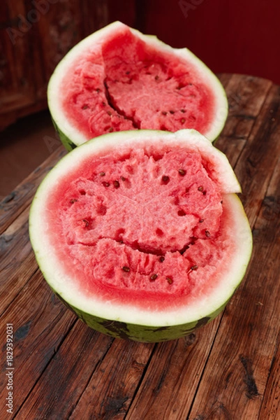 Obraz Fresh Cut Watermelon Halves Showing Sweet Red Flesh and Seeds on Wooden Table