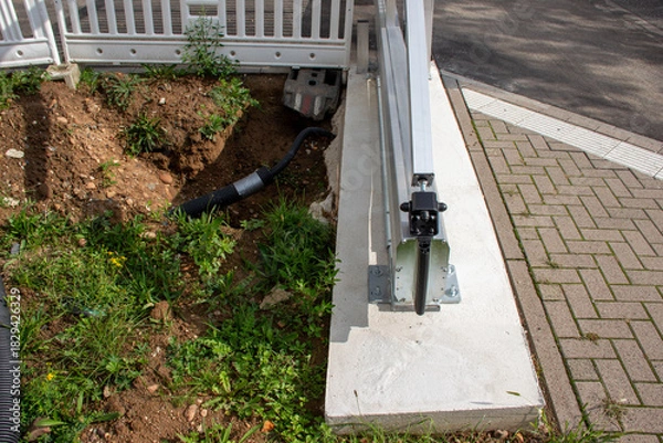 Fototapeta Construction site showing freshly dug earth with green grass, a drainage pipe, and a concrete edge, highlighting landscaping and infrastructure development