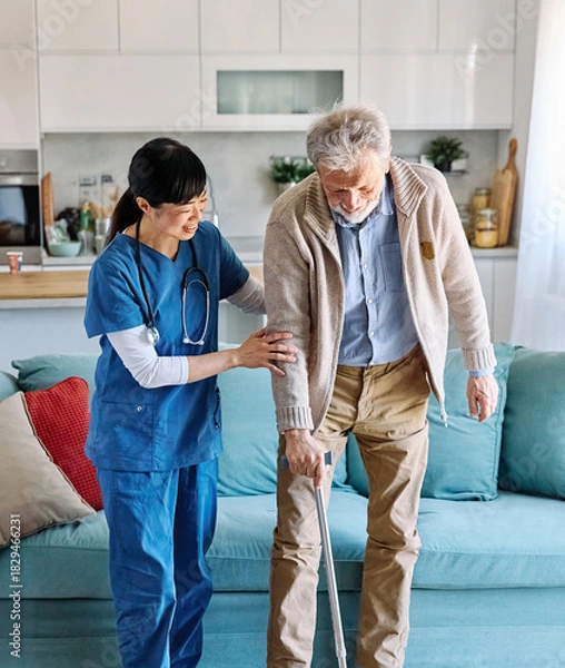 Obraz Doctor or nurse caregiver helping senior man walking  at home or nursing home