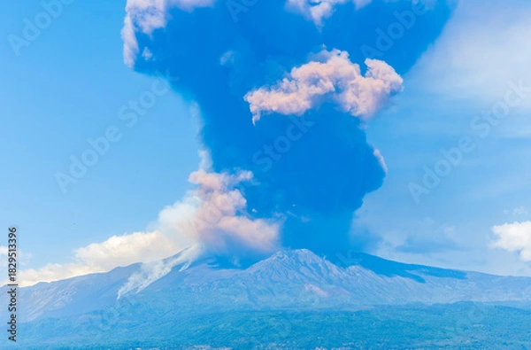 Fototapeta great volcano erupting on blue cloudy sky background. Vulcano Etna during eruprtion with big cloud of vulcanic smoke above the crater.