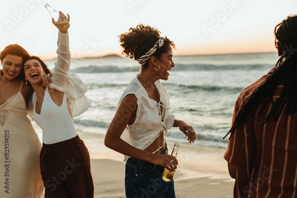 Obraz Friends celebrate on the beach at sunset