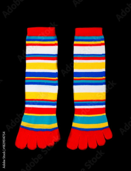 Obraz Multicolored socks on a black background.