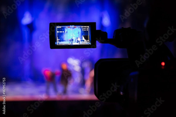 Fototapeta Filming the show from the auditorium. LCD viewfinder on the camcorder. Theatrical performance. The actors on stage. Out-of-focus background. The focus in the foreground.