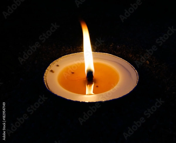Obraz burning candle on black background