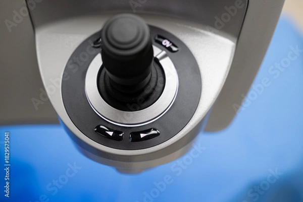 Fototapeta A close-up view of the ergonomic, high-precision joystick control interface used by the surgeon to manipulate and position the ZEISS Femtosecond Laser System during refractive eye surgery (SMI