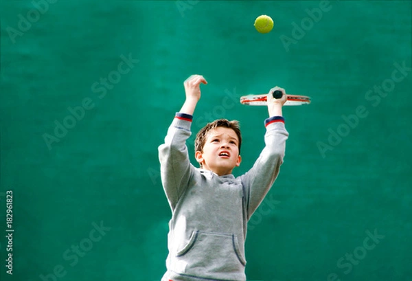 Obraz Little tennis player on a blurred green background